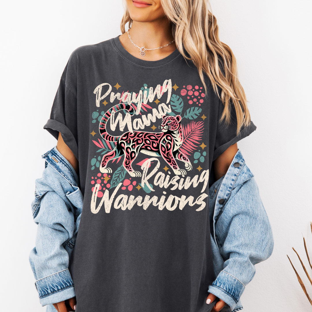 Woman wearing Praying Mama Raising Warriors graphic tee – Comfort Colors faith-based shirt