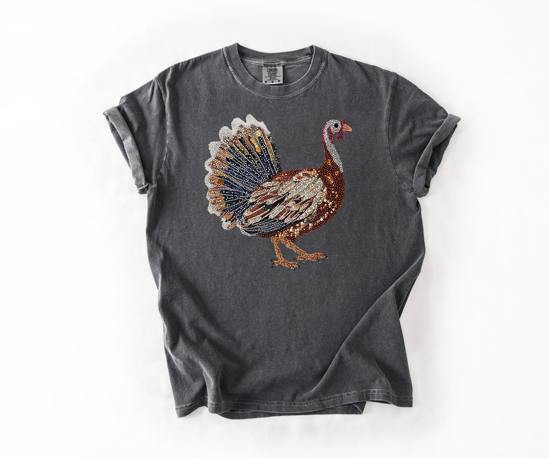 Gray t-shirt with a colorful turkey graphic on a white background