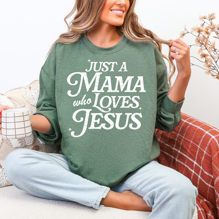 Person wearing a green sweatshirt with text, sitting on a couch holding a mug.