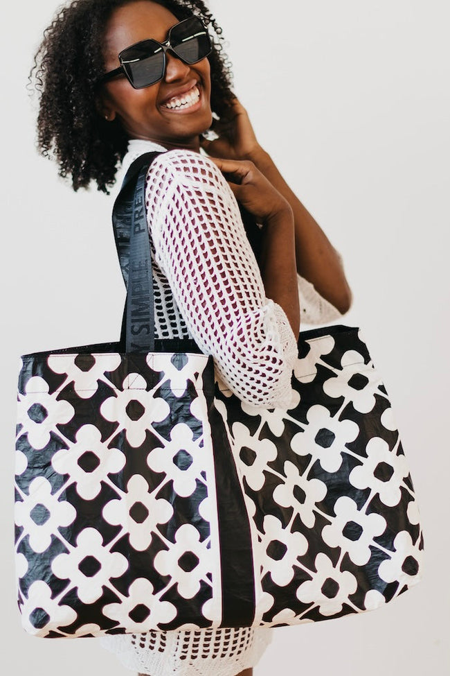Stylish beach tote bag with "Pretty Simple" logo straps
