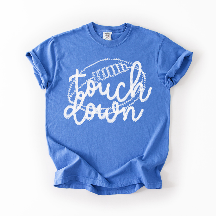 Blue t-shirt with 'touchdown' text on a white background