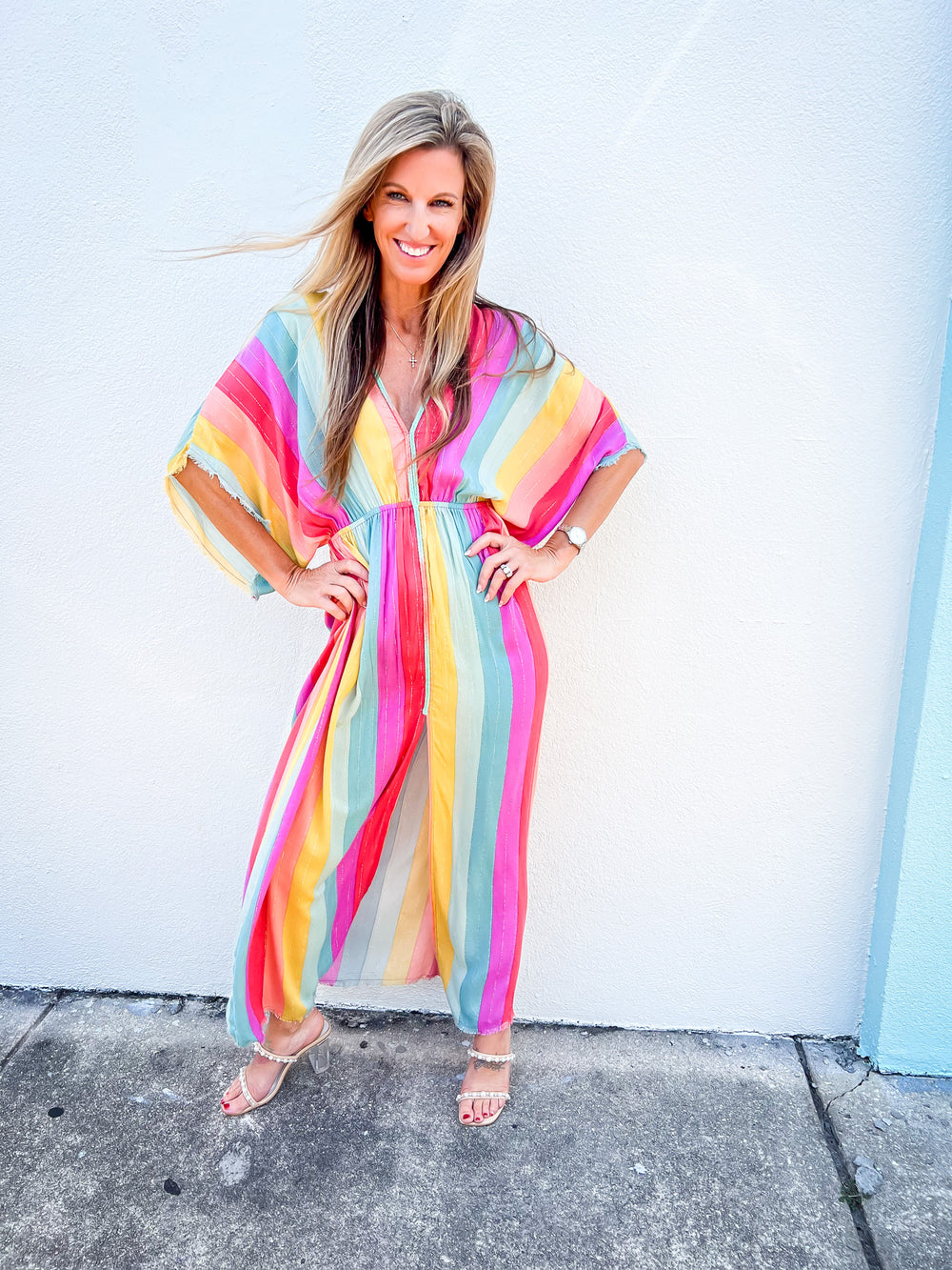 Model wearing colorful Harlequin Maxi Dress with rainbow stripes and metallic shimmer