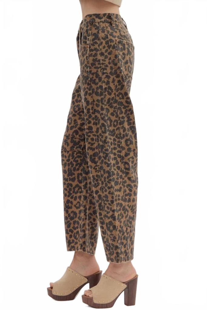 Leopard print pants worn by a person on a white background