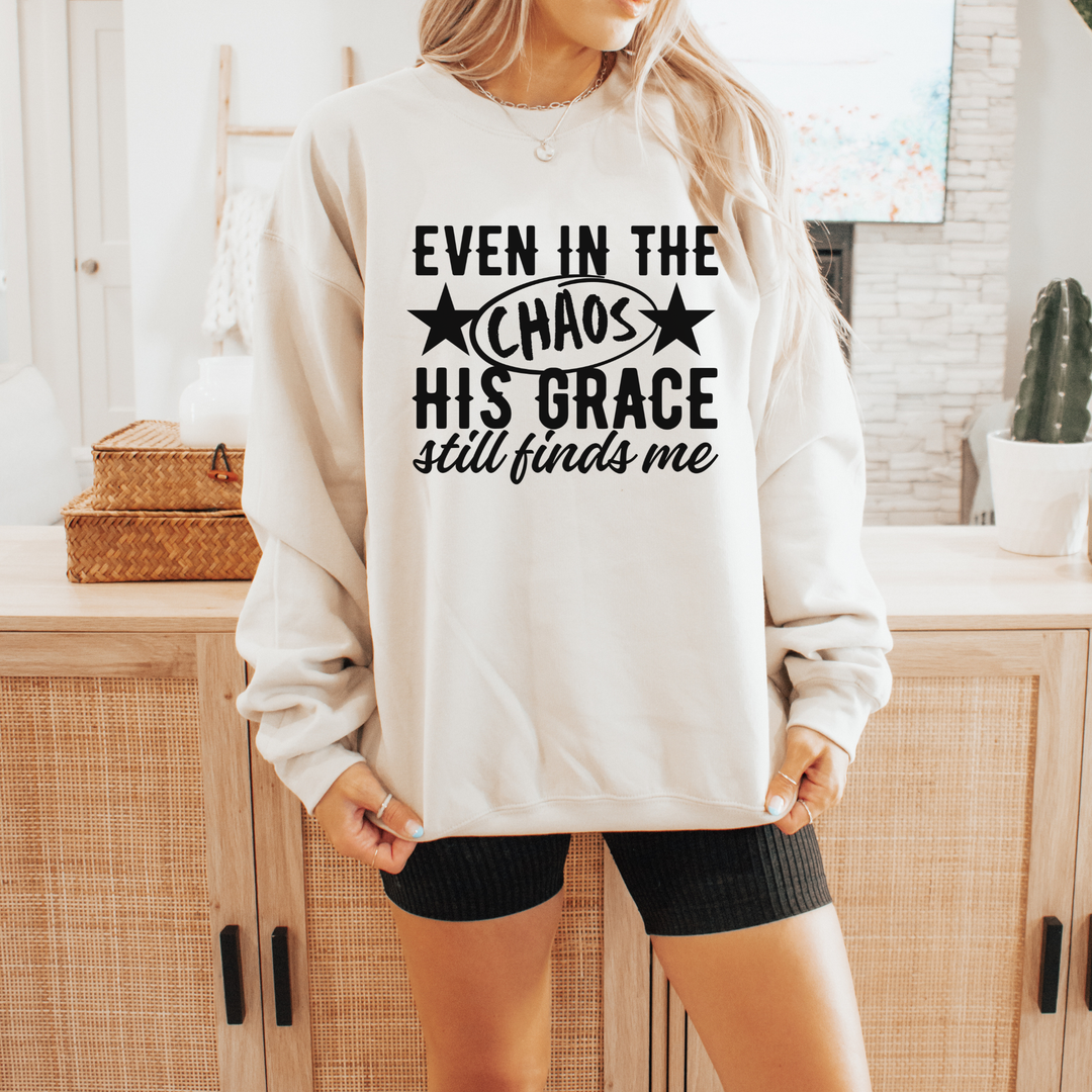 Person wearing a white sweatshirt with text in a kitchen setting